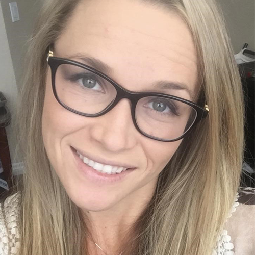 woman with glasses smiling