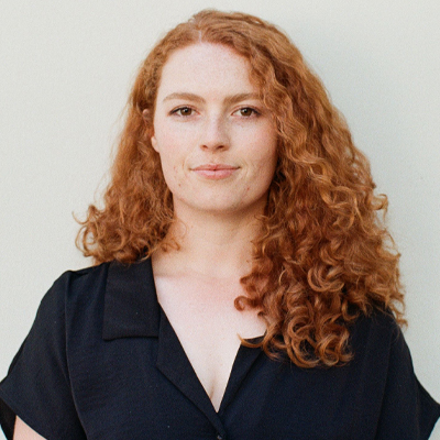 woman with red curly hair smiling