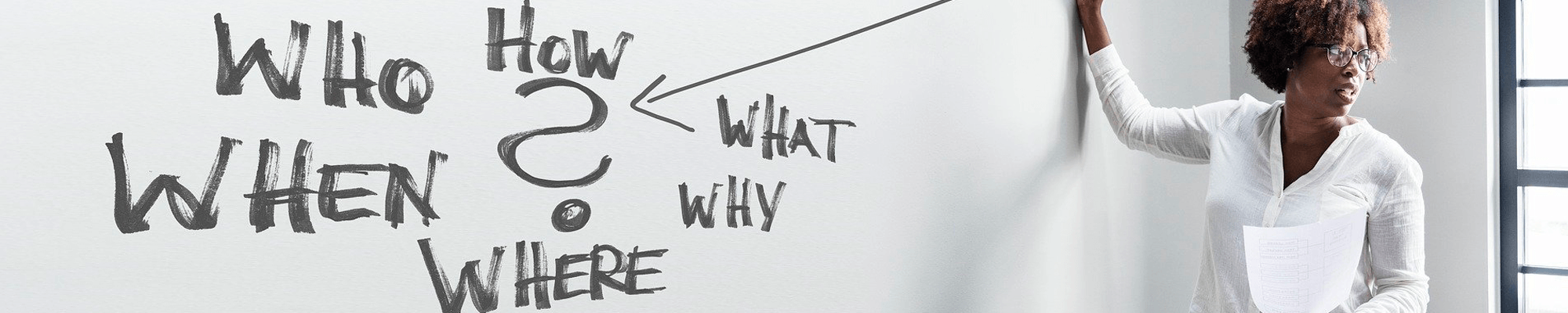 instructor writing on whiteboard- who? what? when? why? How?